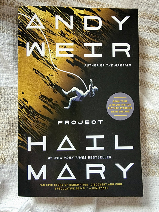 Book cover of 'Project Hail Mary' by Andy Weir on a textured fabric background
