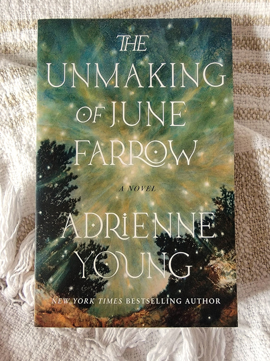Book cover of 'The Unmaking of June Farrow' by Adrienne Young on a textured surface.