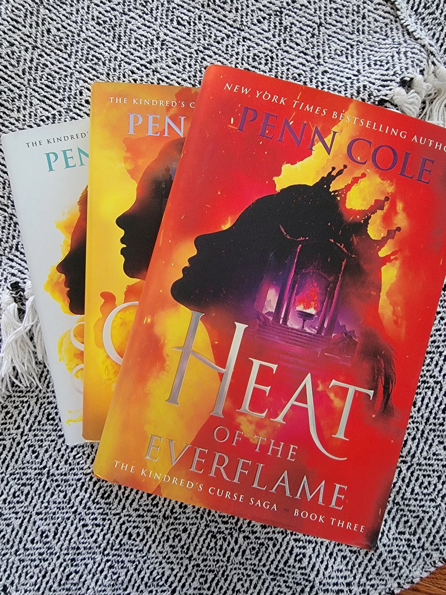 3 books in the kindreds curse saga on a textured black and white background
