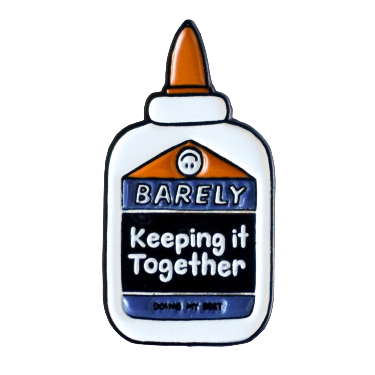 Close-up of enamel pin with glue bottle design and text 'Barely Keeping It Together'