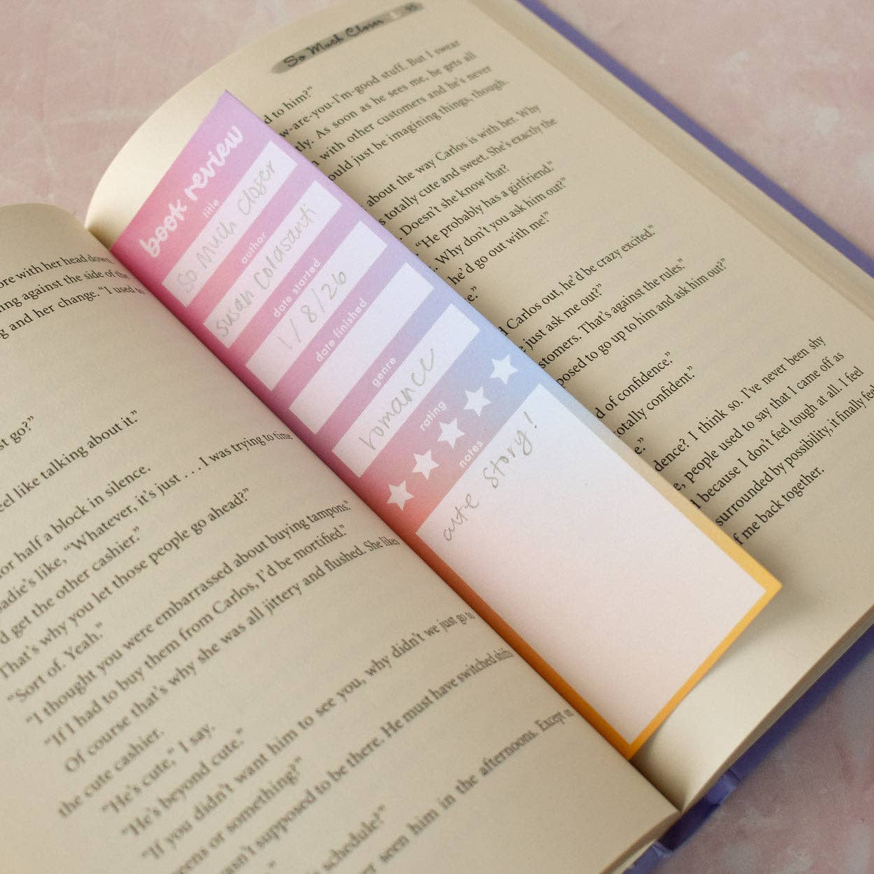Colorful bookmark with book review text on an open book