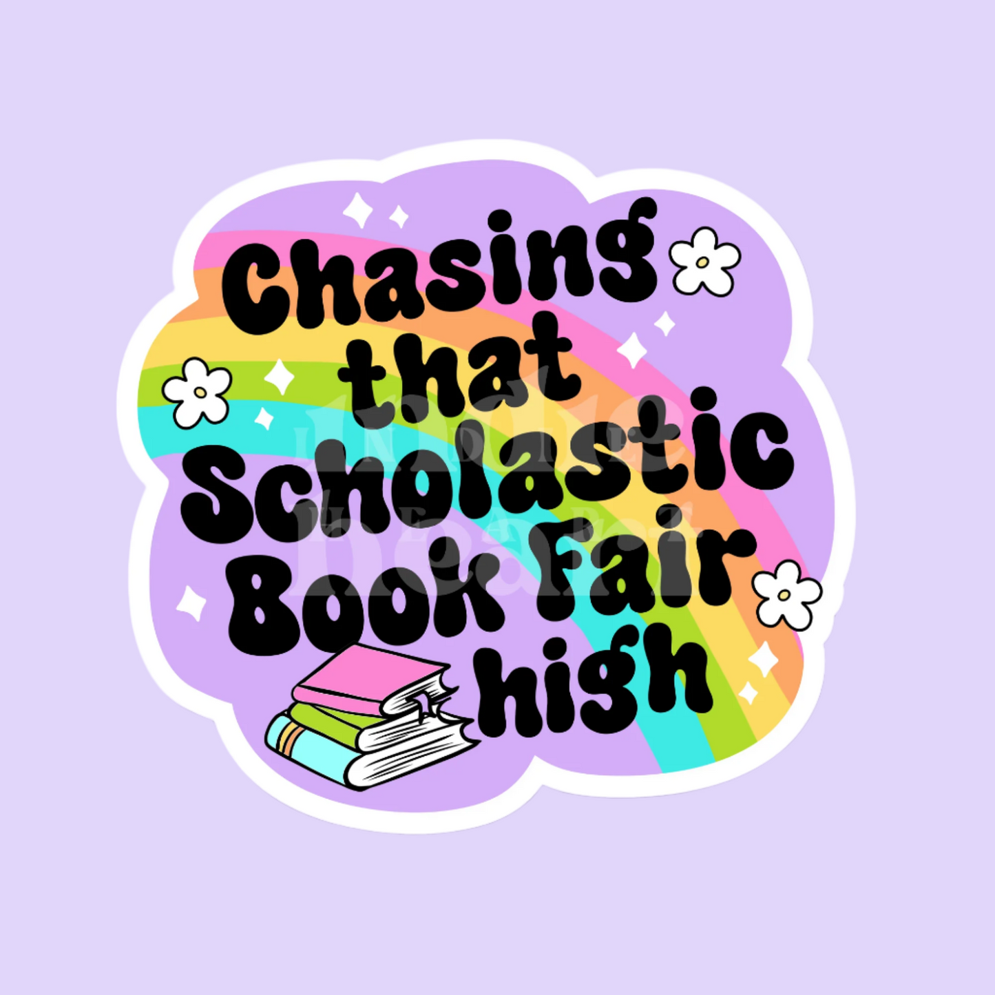 A colorful vinyl sticker with text 'Chasing that Scholastic Book Fair high' on a purple background with illustrations of books and flowers.