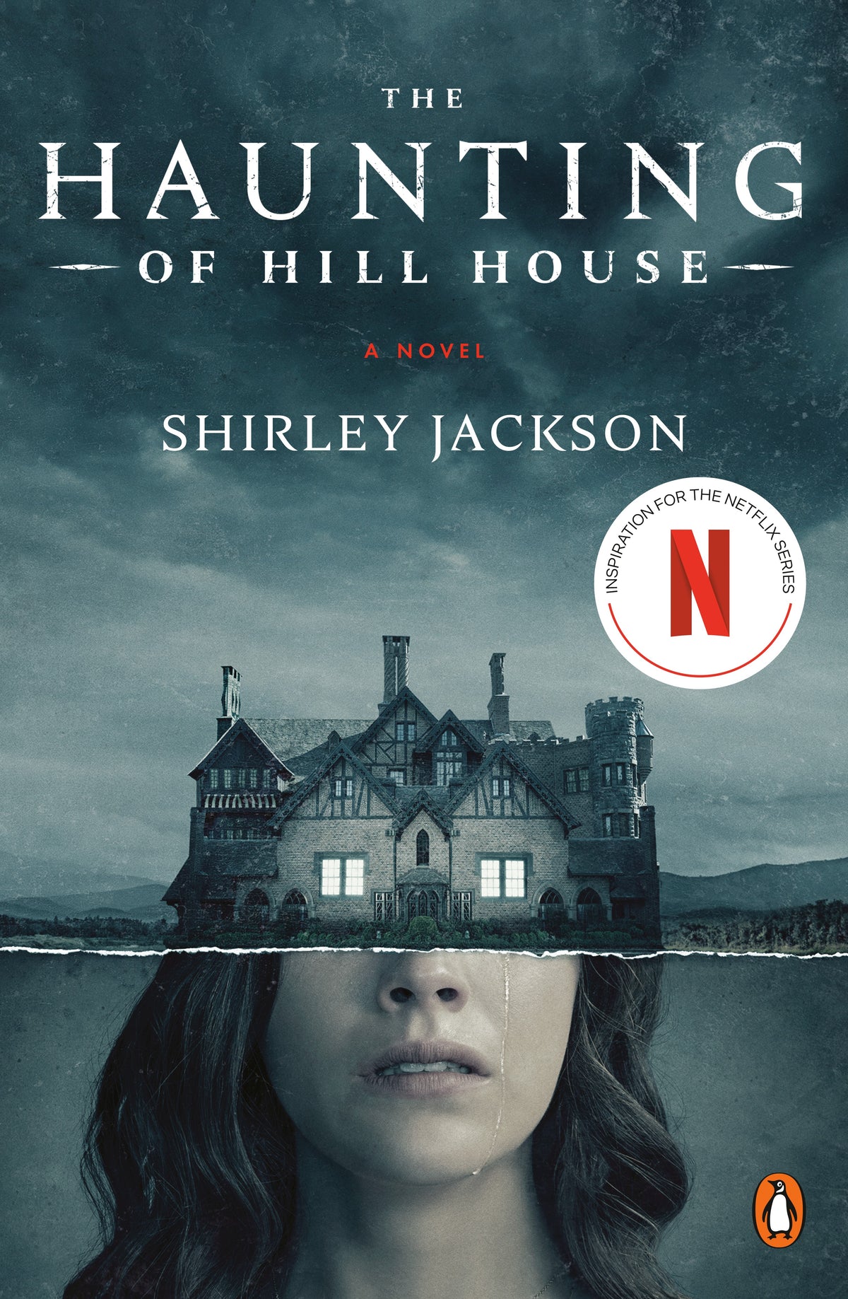 book cover of the haunting of hill house. a large dark home sits atop a womans crying face. 