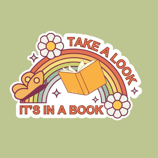 A waterproof sticker with a colorful design featuring a rainbow, flowers, and an open book with the text 'TAKE A LOOK IT'S IN A BOOK'.